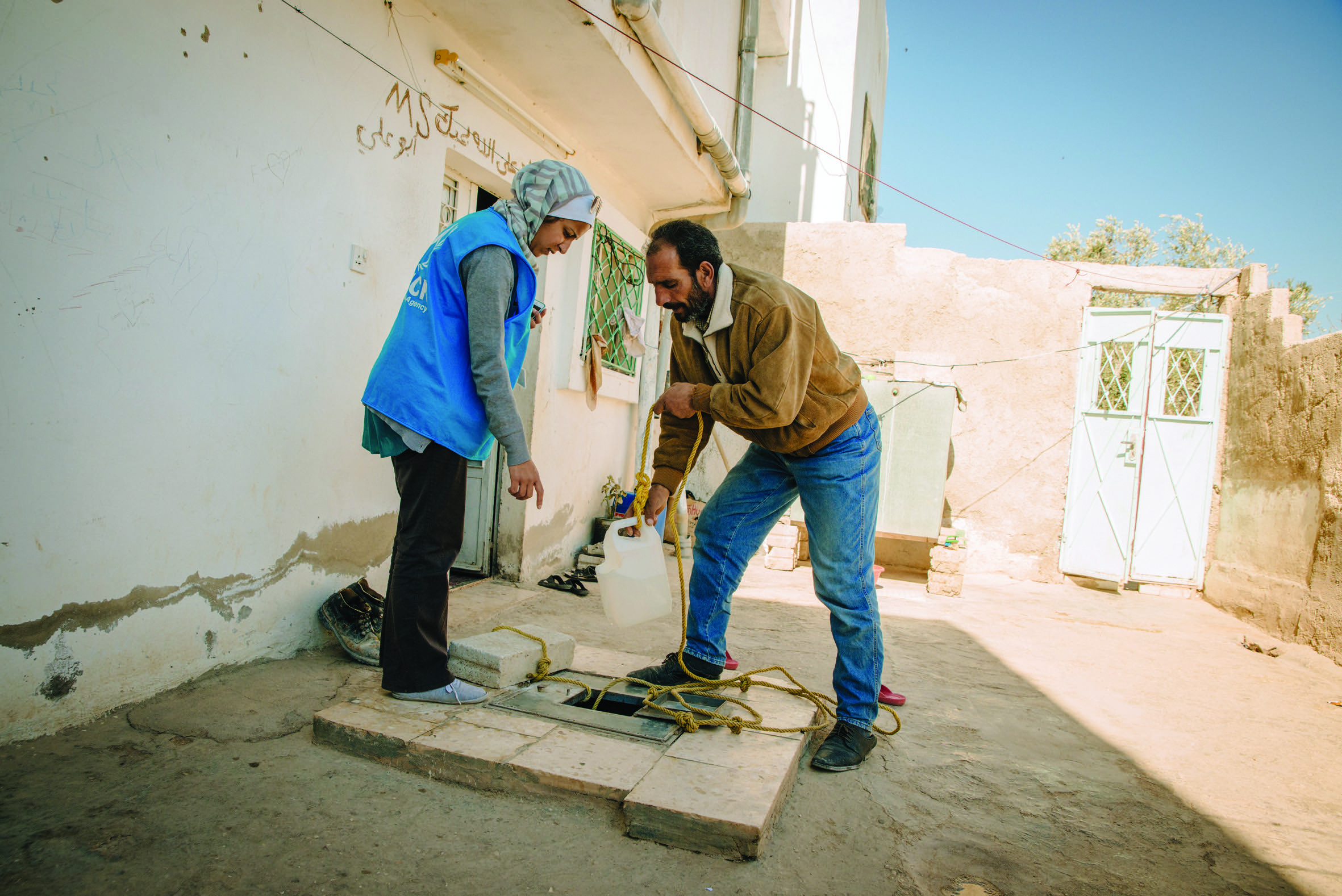 Abu Khaled shows the well his family uses for non-potable water in Irbid.