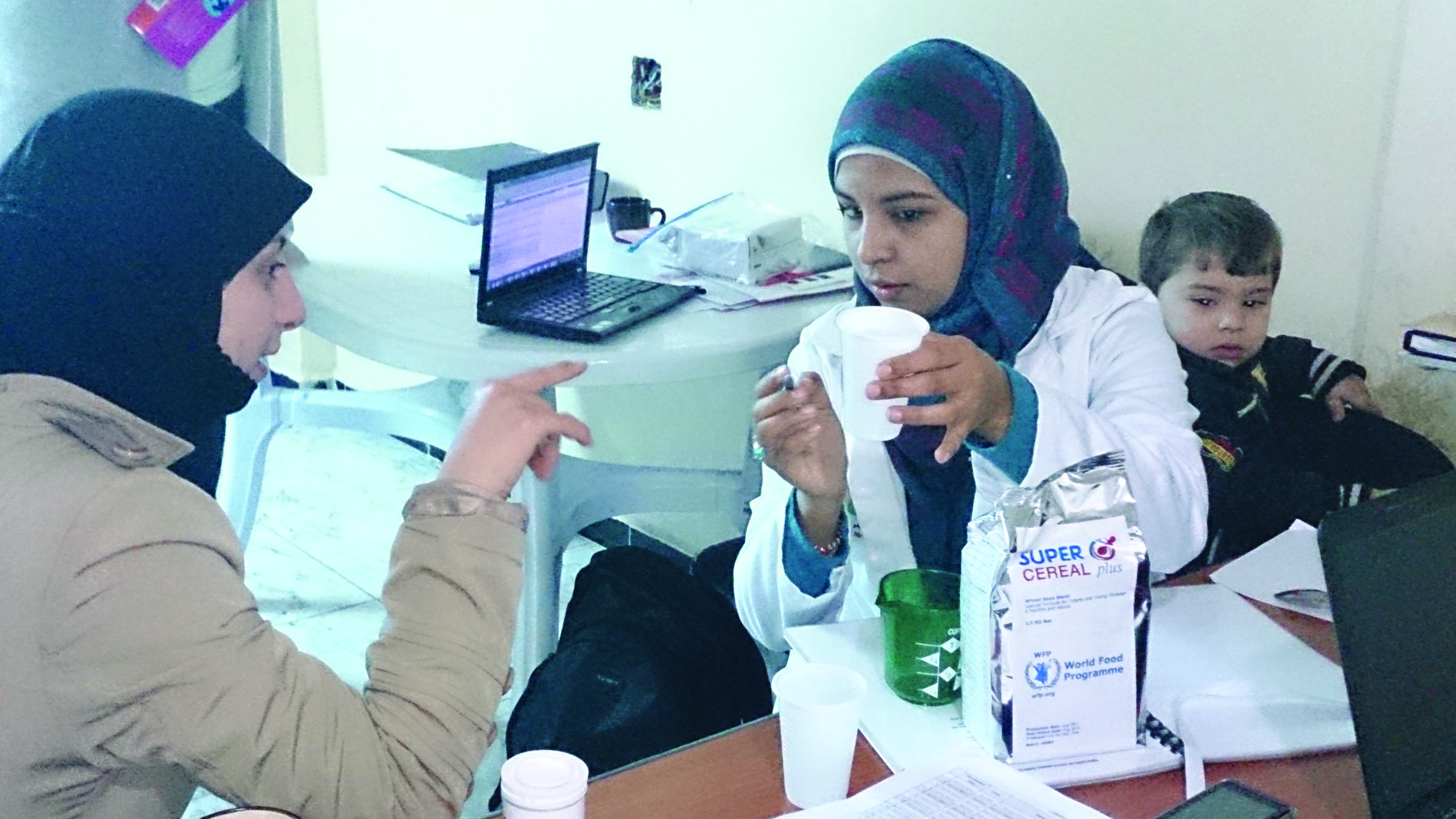 Teaching how to prepare Super Cereal Plus in an Amman clinic