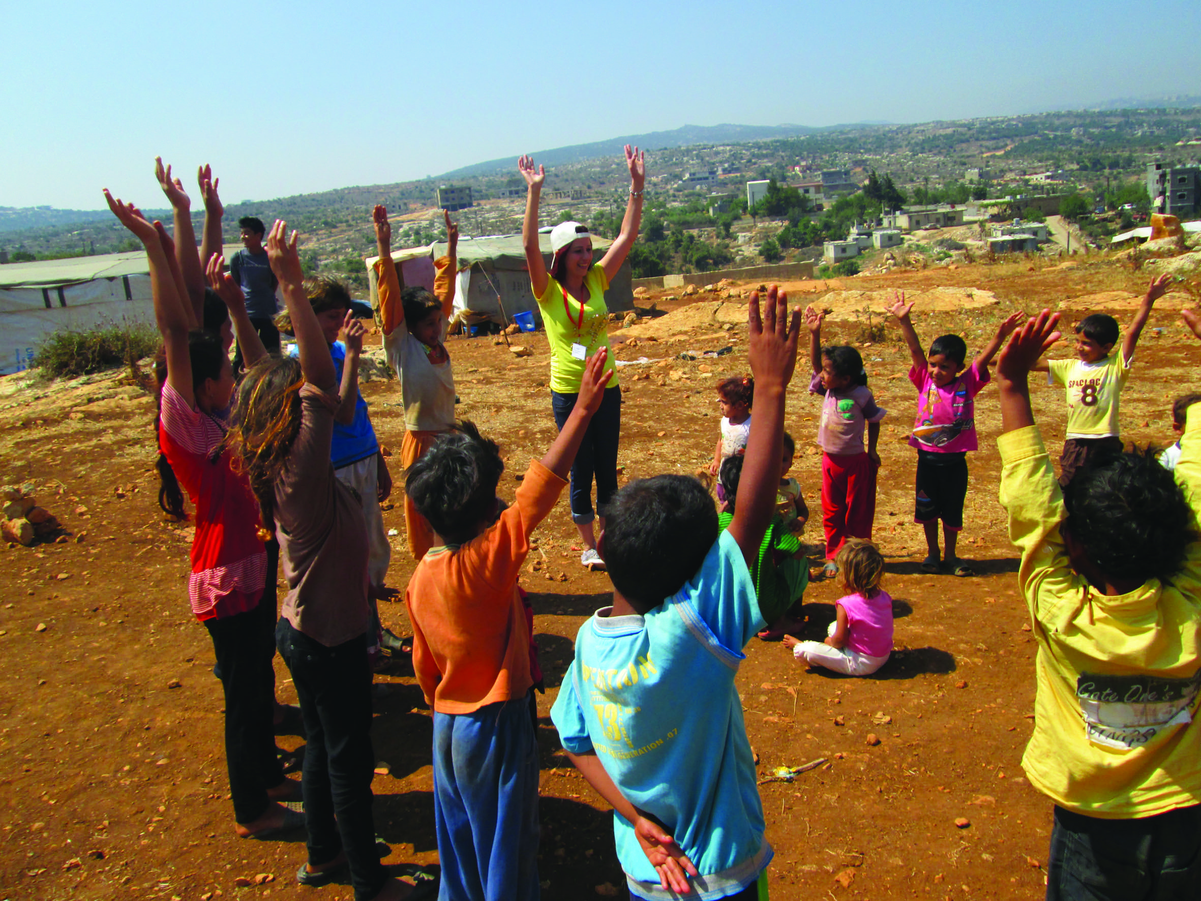 Community mobilisers from SC run a mobile Child Friendly Space during a distribution of shelter kits and NFIs in an Informal Settlement in Akkar District, North Lebanon