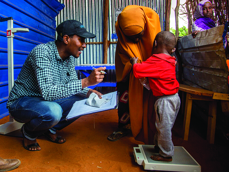 A child is weighed at an outpatient therapeutic centre in Kabasa IDP Camp in Dolow