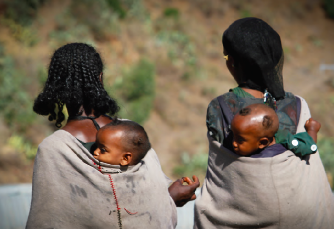 Women with children walking to Bella health post, Amhara region, Ethiopia
