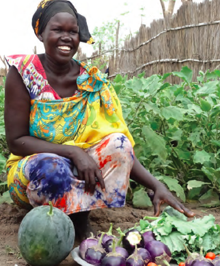 Woman in Unity State demonstrating ingredients for a diversified meal