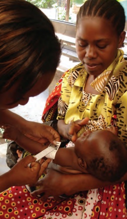Measuring MUAC of an infant, Kilifi County Hospital, Kenya