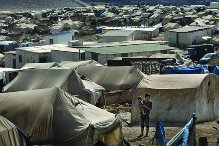 A man and a boy in Atma, an encampment for displaced persons, near the border with Turkey