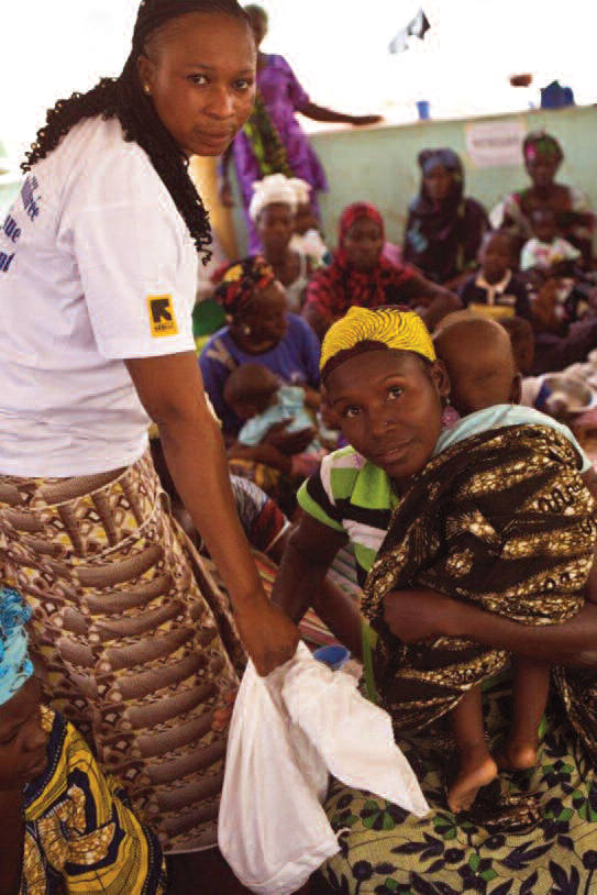 Beneficiaries waiting in the OTP programme with an IRC supervisor
