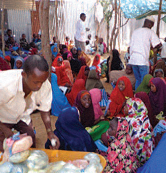 School staff distributing food to students after school lessons