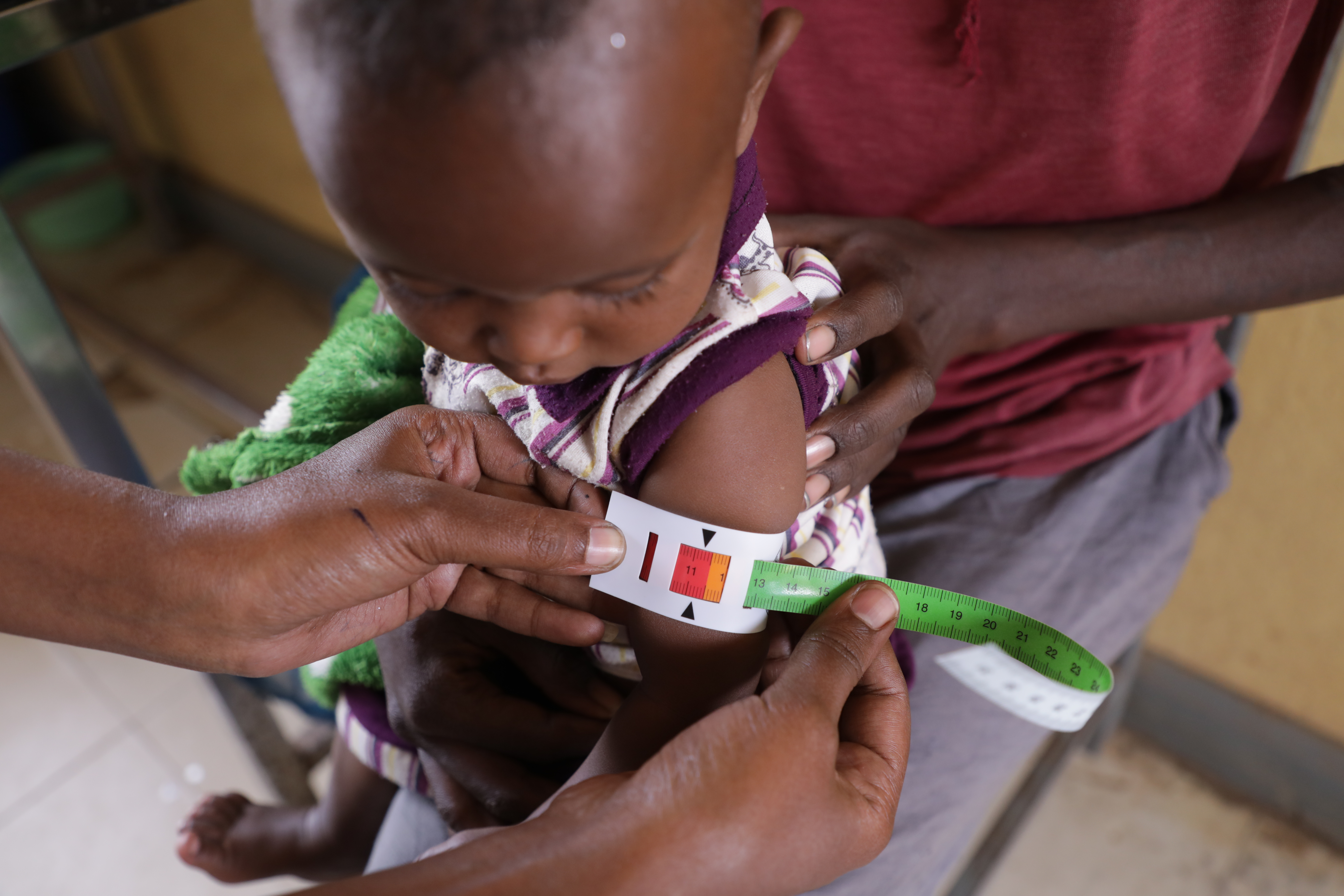 A girl having her arm's circumference measured