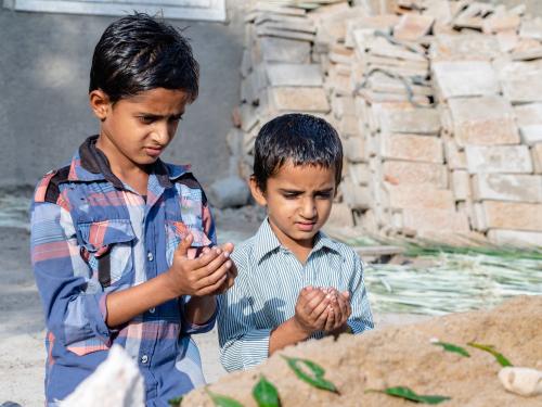 Two brothers praying in Pakistan