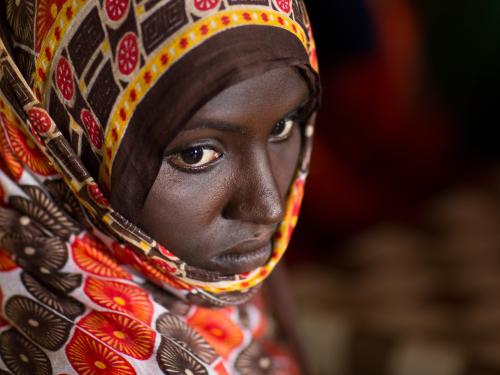Ethiopian woman looking down wearing a headscarf
