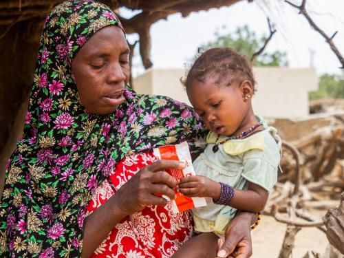 Caregivers receiving a ready-to-use therapeutic food (RUTF) sachet in Nara. Mali, 2020