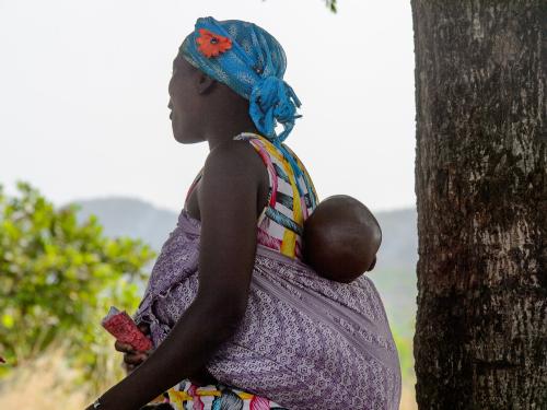 Woman carrying child on her back