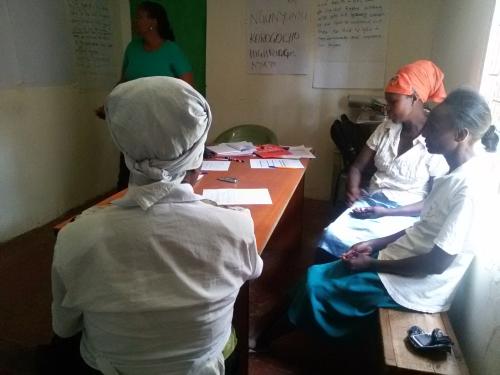 grandmothers from Korogocho listen to the moderator as she takes them through the costing process of the outcome of interest