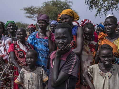 a crowd of figures standing outside