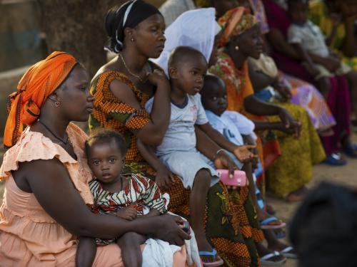 Mothers and children sitting waiting for medical facility