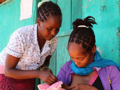 Front cover of document titled, "operational guidance: breastfeeding counselling in emergencies, July 2021." Image shows a woman helping a mother breastfeed her baby.
