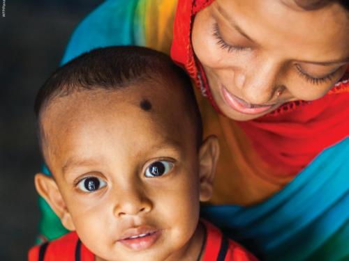 Front cover of report titled, "Wasting and Stunting Technical Interest Group Meeting 12 – 13 May 2020." Picture shows woman and child sitting on her lap.