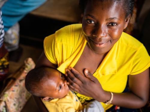 A mother feeds her child during a sensitisation  on nutrition demonstration in Malawi