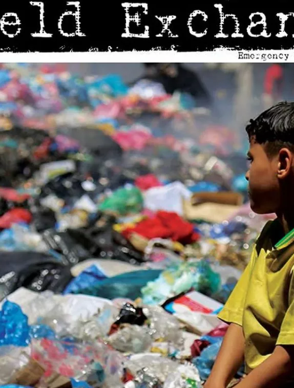 Front cover image shows a boy looking out over rubbish dump.