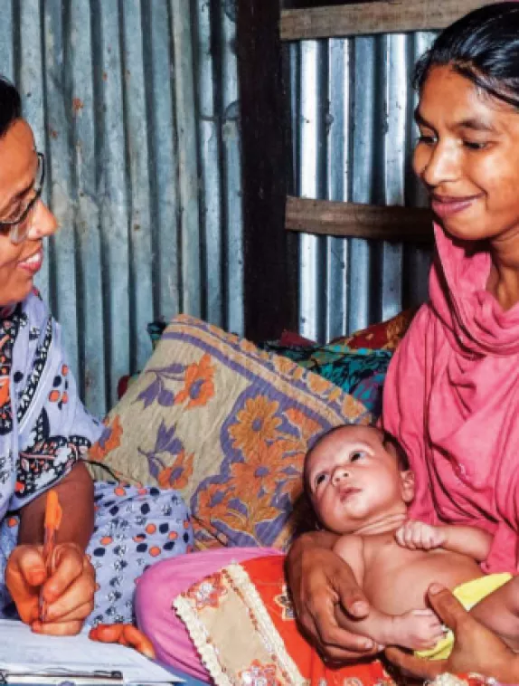 Front cover of document titled, "Special section on MAMI: Management of at risk mothers and infants under six months." Image shows a healthcare worker speaking to a mother about her baby during assessment.