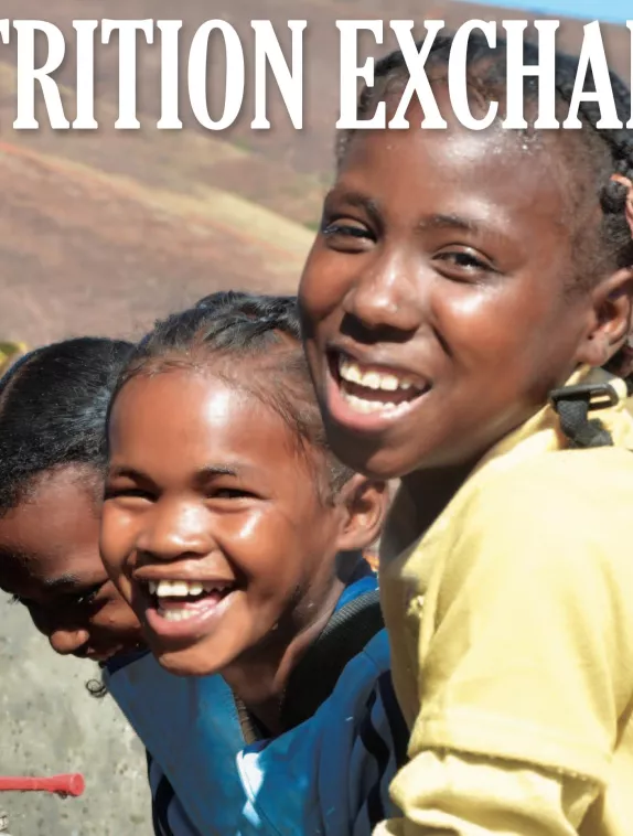Front cover of issue 4 English version of Nutrition Exchange. Image shows three girls washing their hands.