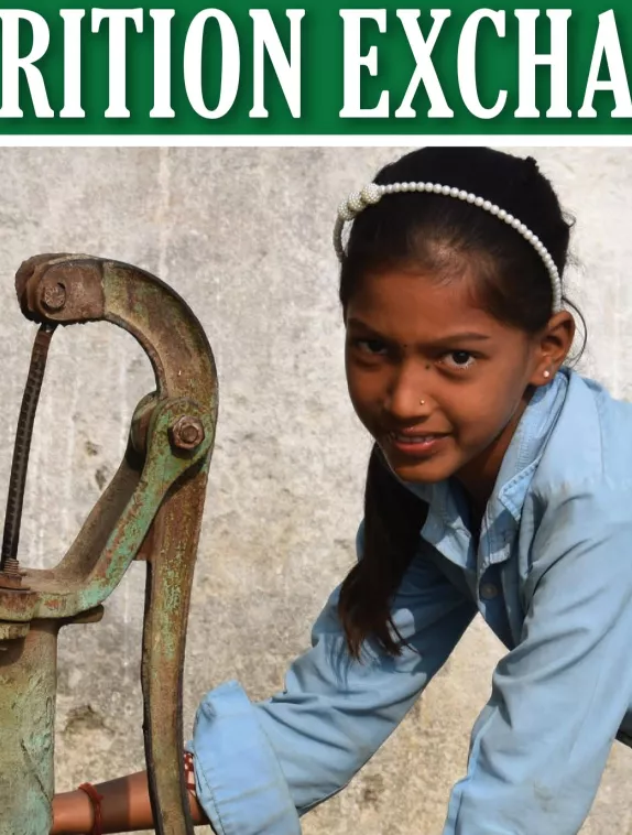Front cover of English version of Nutrition Exchange Issue 12. Image shows a school girl collecting water from a water pump.