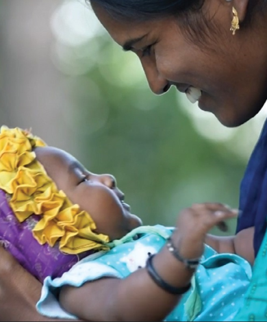 Woman smiling at baby