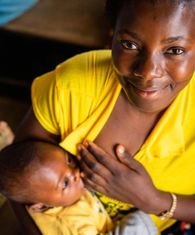A mother feeds her child during a sensitisation  on nutrition demonstration in Malawi