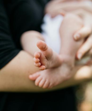 Woman with young baby in her arms