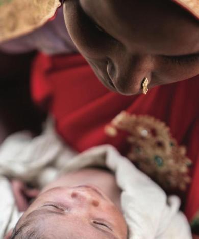 A photo of an asian woman holding a baby