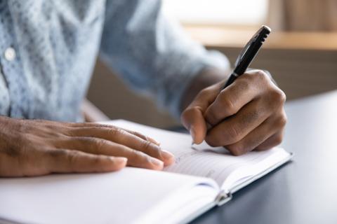 person writing a letter