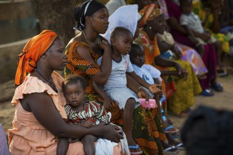 Mothers and children sitting waiting for medical facility