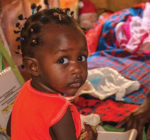 young girl from Kenya being weighed