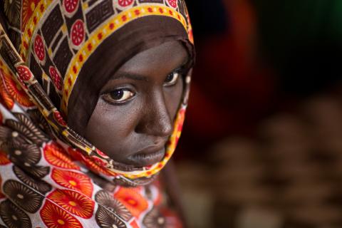 Ethiopian woman looking down wearing a headscarf