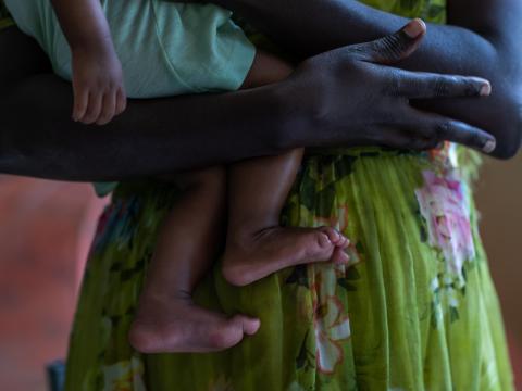 A close-up of an Ethiopian mother holding her baby