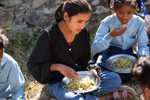 Two school girls eating lunch.