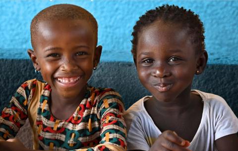 Front cover of the report 'Building synergies between child nutrition and social protection' with two children smiling