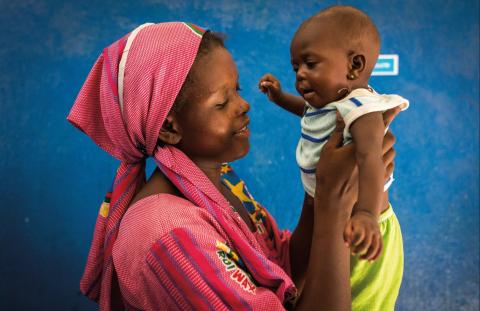 Mother holding baby up with both hands