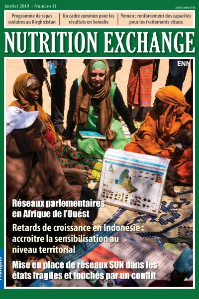 Front cover of Issue 11 French. Image shows a group of women sitting and learning about nutrition.